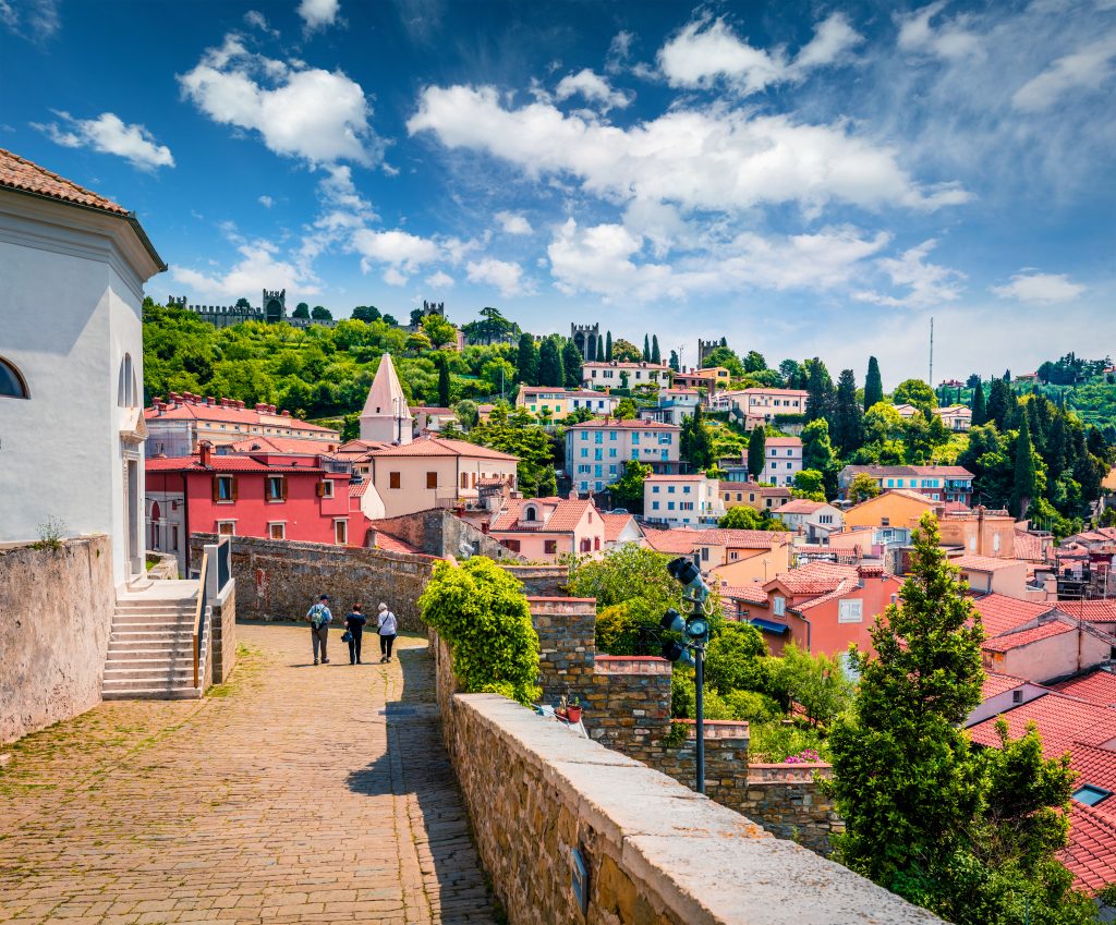 view of buildings of piran slovenia seen near st georges church, one of the best things to do in piran slovenia