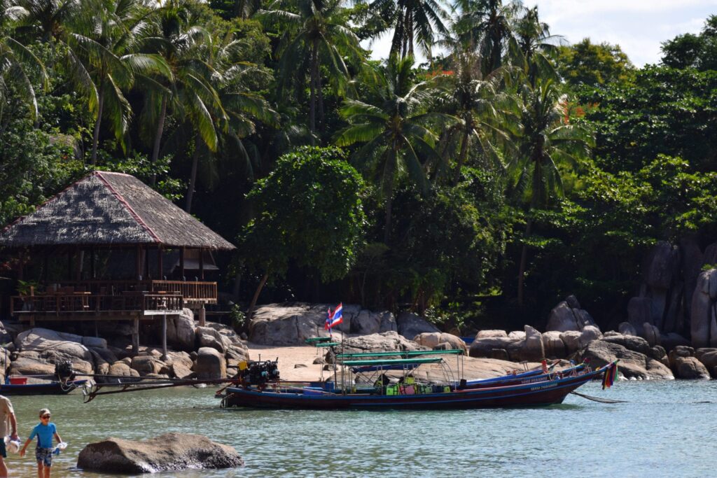 long tail boat parked near a beach in koh tao thailand