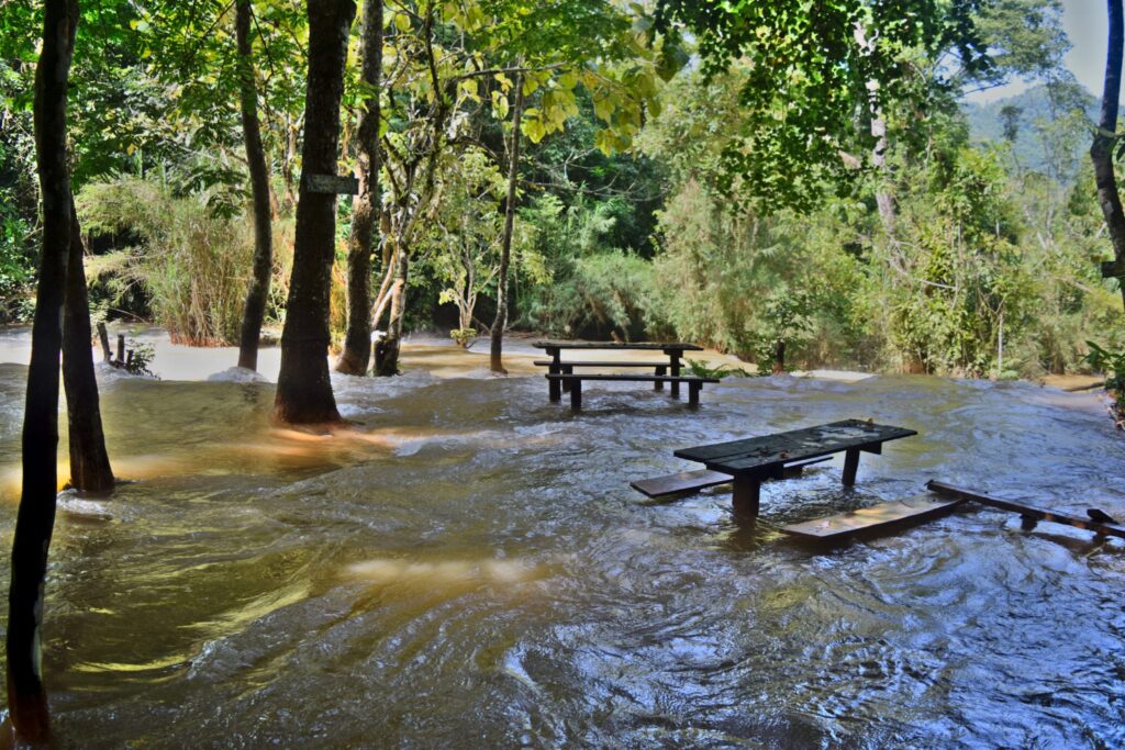 flooded picnic area at kuang si during the laos rainy season