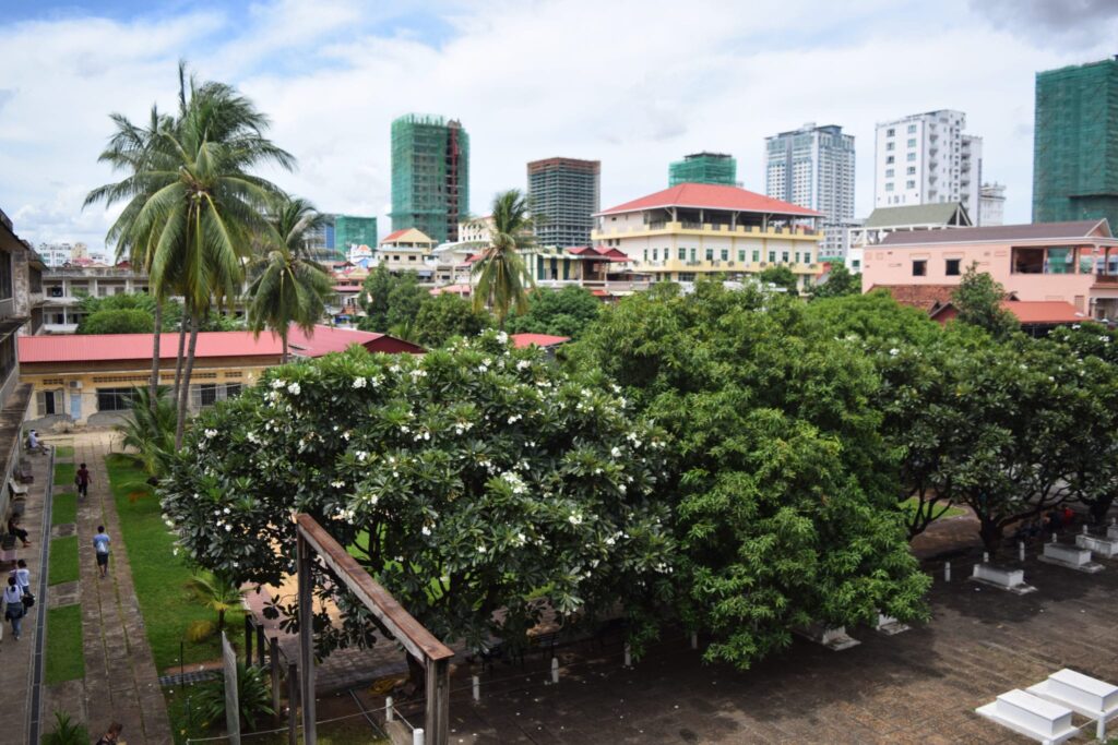 view of the courtyard with flowering trees at tuol sleng phnom penh cambodia