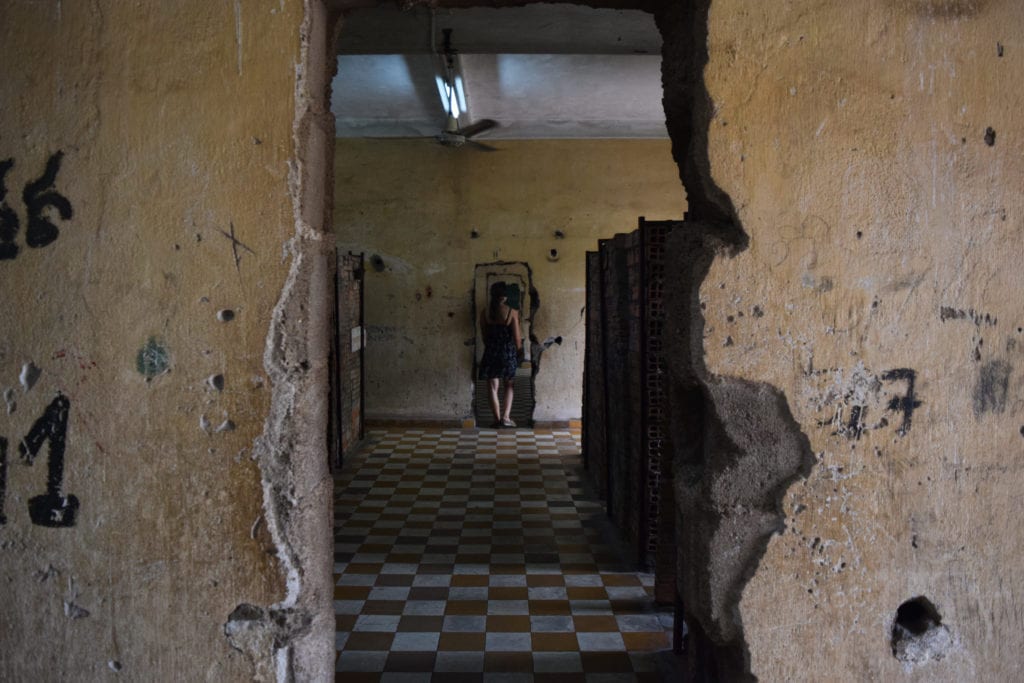 view of a rough doorway carved into a wall at s21 cambodia
