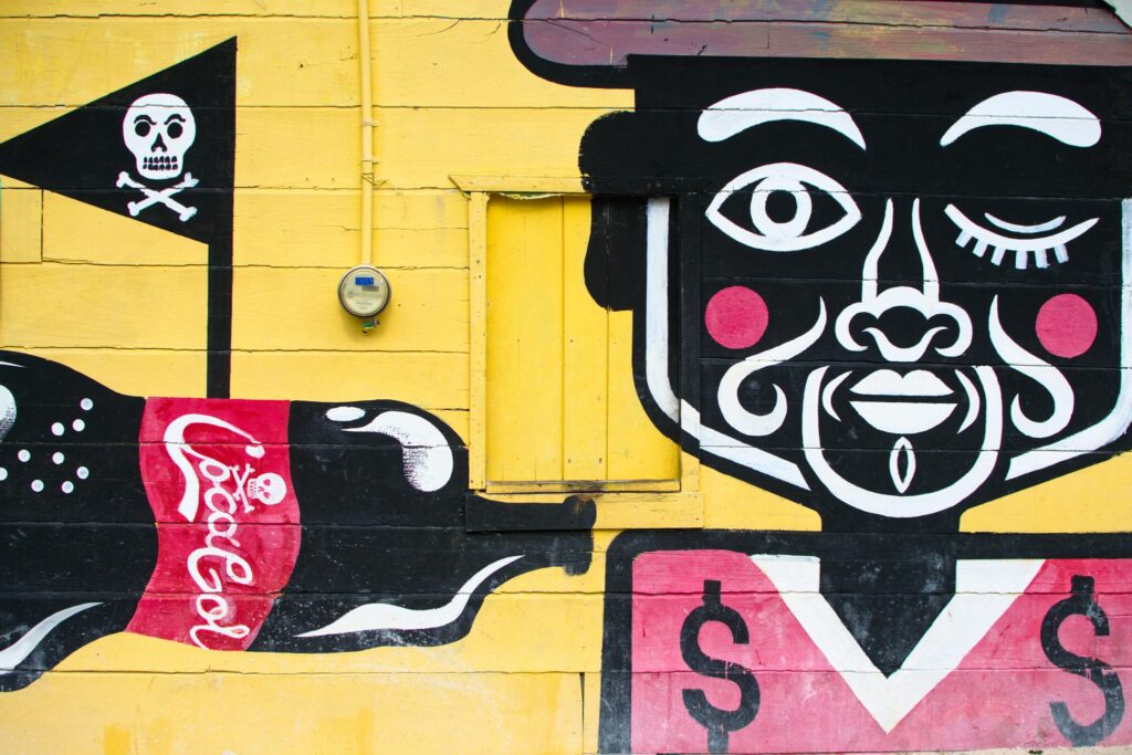 mural of a man holding a coca cola on a yellow background, one of the best things to see holbox island mexico