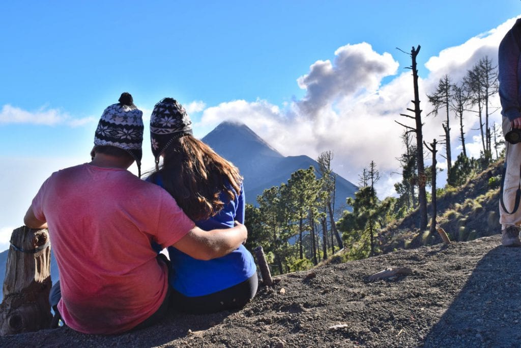 kate storm and jeremy storm overlooking fuego from acatenango after climbing acatenango