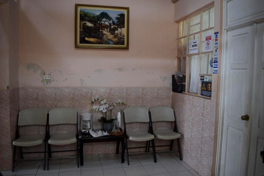 waiting room of a dentist in guatemala with 4 plastic chairs