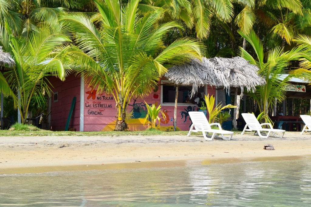beach chairs on a small beach in bocas del toro panama