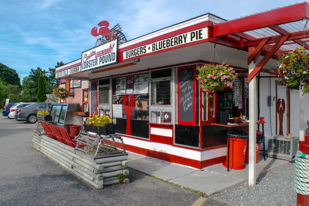 view of a red and white lobster pound in new england