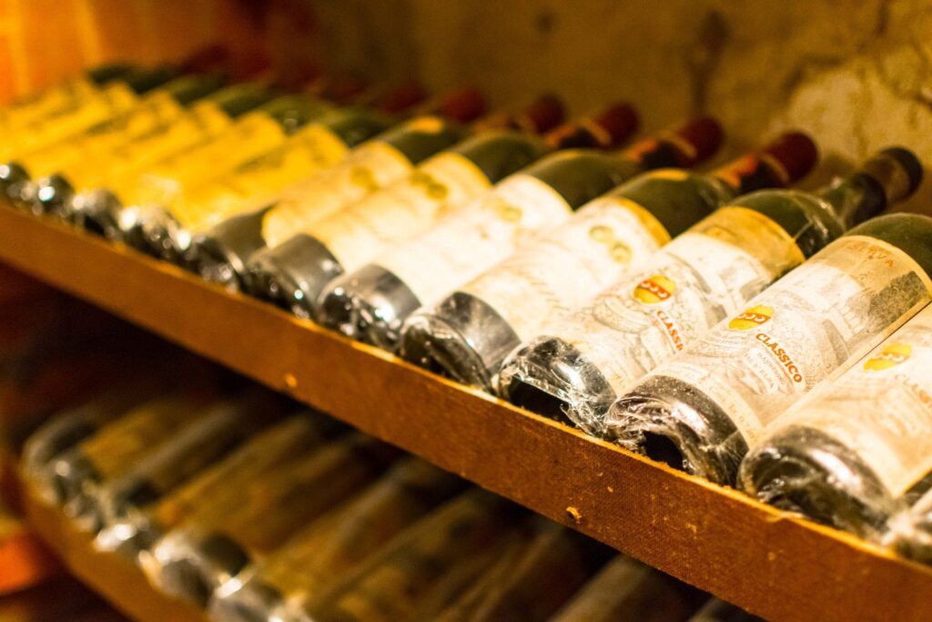 bottles of wine in a cellar as seen on a tour of some of the best things to eat in florence italy
