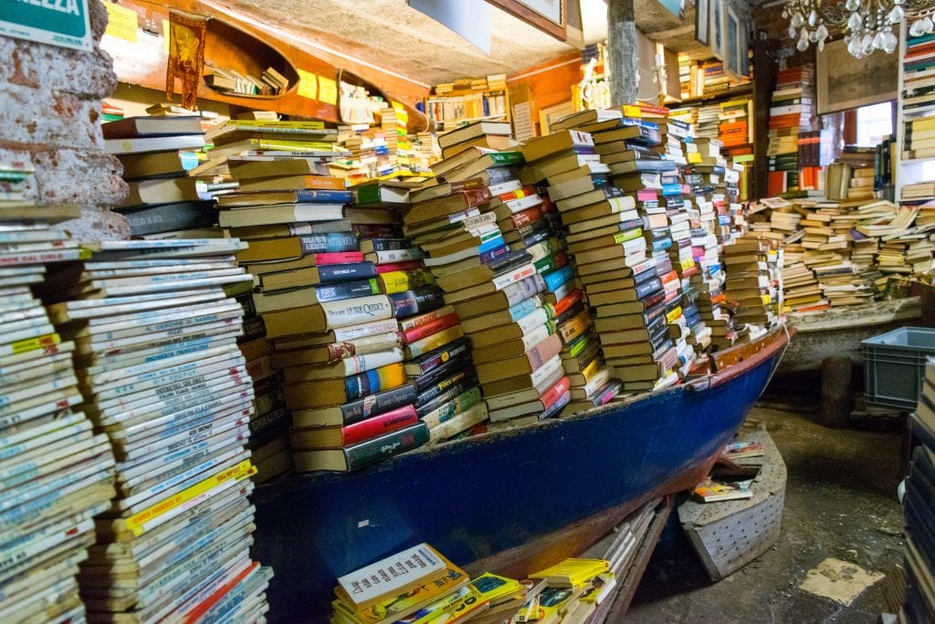 Canoe full of stacks of books in Libreria Acqua Alta Venezia