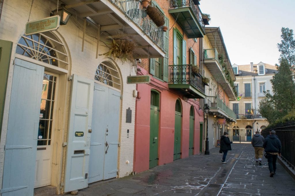 Pirate Alley in New Orleans Louisiana with buildings on the left side of the photo--be sure to check out this spot during your 3 days in New Orleans