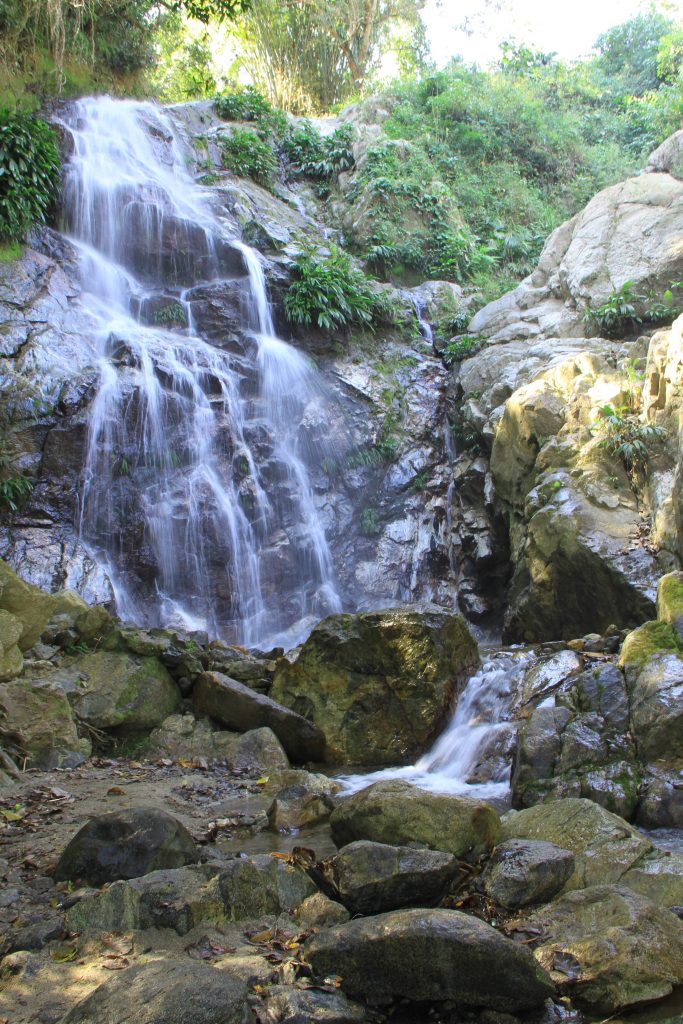 vertical photo of marinka falls, one of the best minca colombia waterfalls to visit