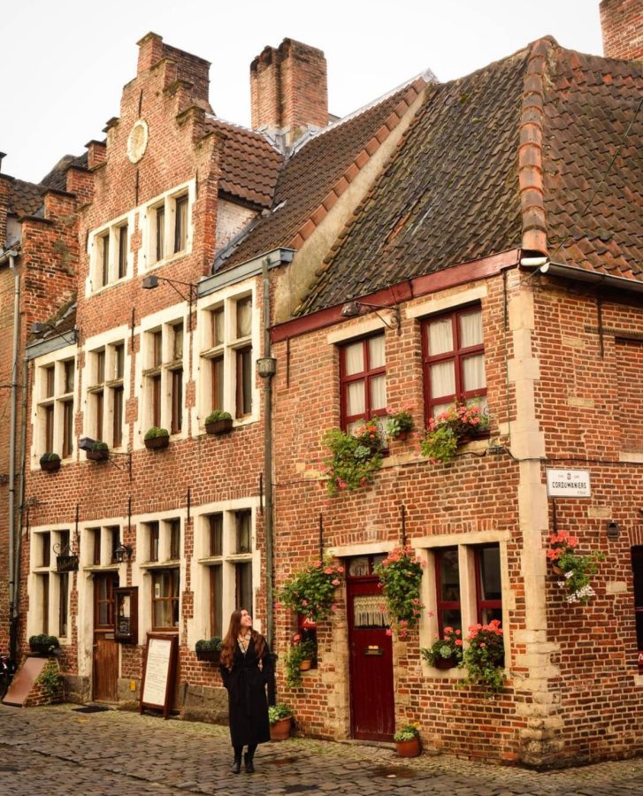 kate storm in front of brick buildings in patershol neighborhood during one day in ghent belgium