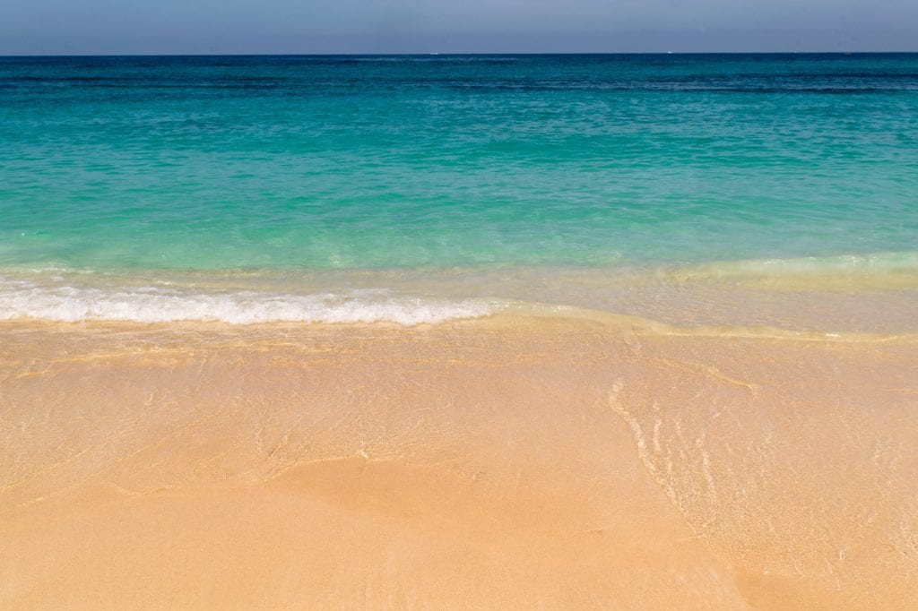 Golden sand and turquoise water of Playa Blanca Cartagena as seen when looking down