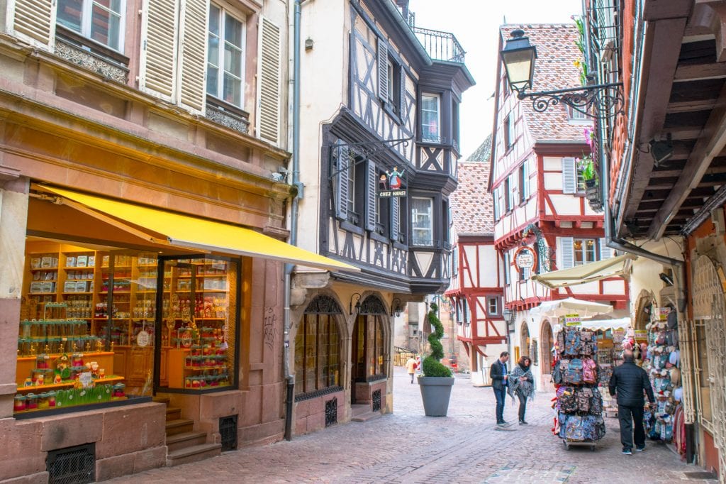 Small shopping street in Colmar France's Old Town with half-timbered houses on either side