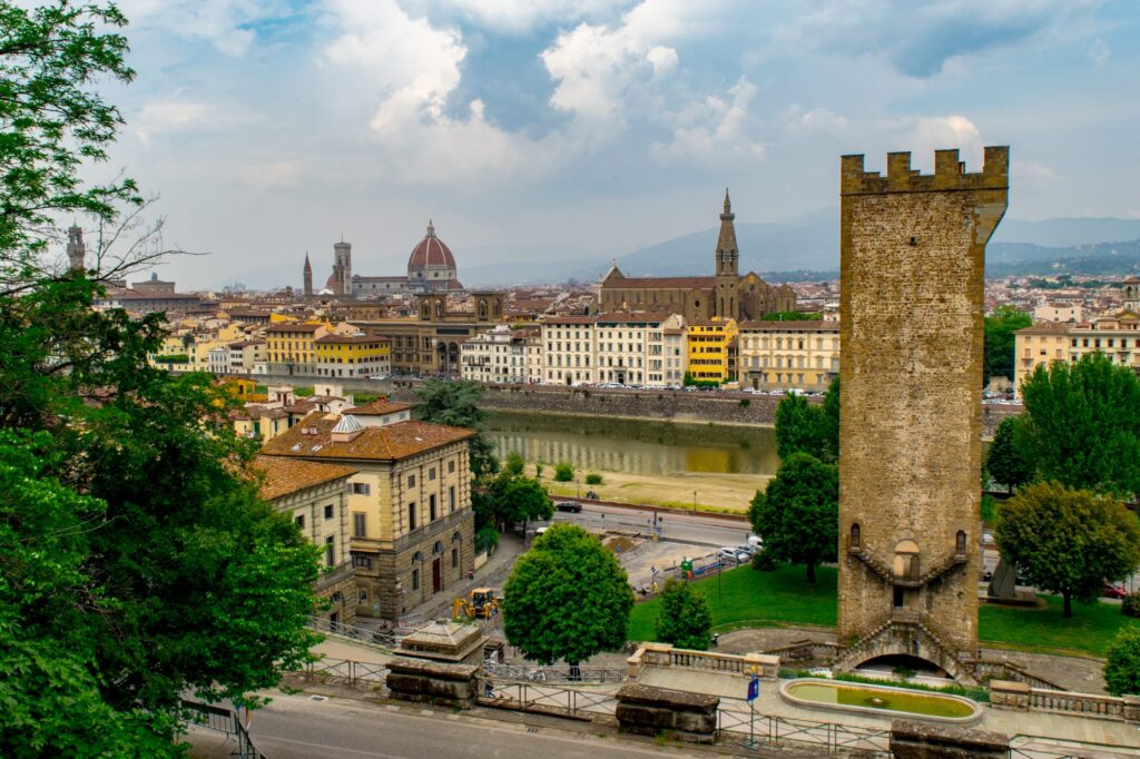 tower of san niccolo in florence italy on the right of the photo, with arno and duomo visible in the distance