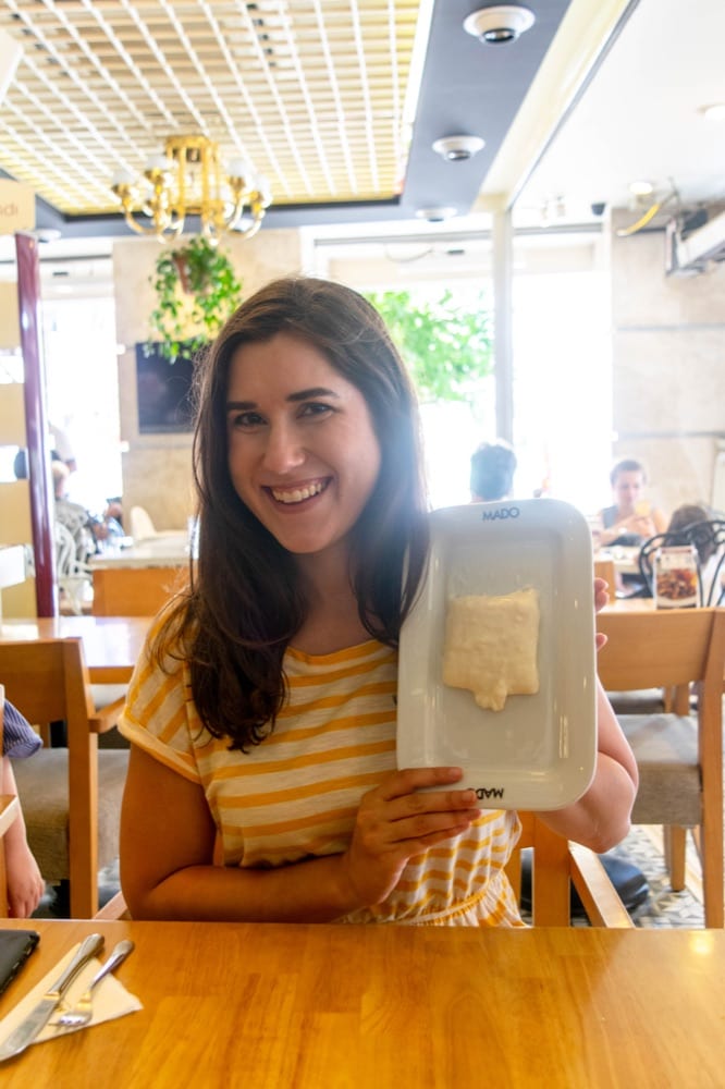 kate storm holding up a plate Tavuk göğsü during an istanbul food tour