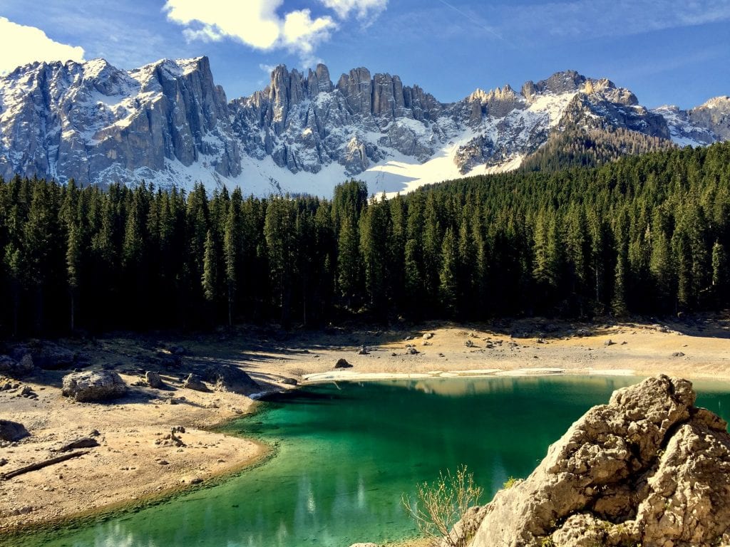 photo of lake carezza italy with dolomites visible in the background, one of the best lakes to visit in italy