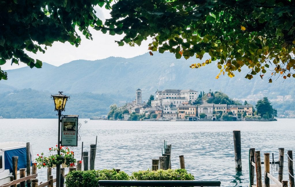 view of island as seen from shores of lake orta, one of the most beautiful lakes in italy