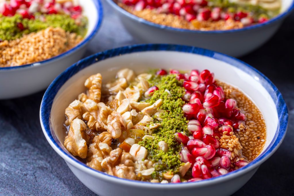 colorful bowl of asure pudding, a popular istanbul dessert food