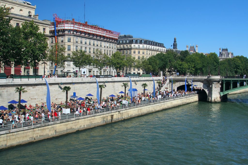 paris plages along the seine in august as seen from across the river
