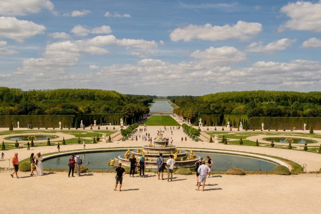 view of the versailles gardens from just outside the palace on a versailles day trip from paris