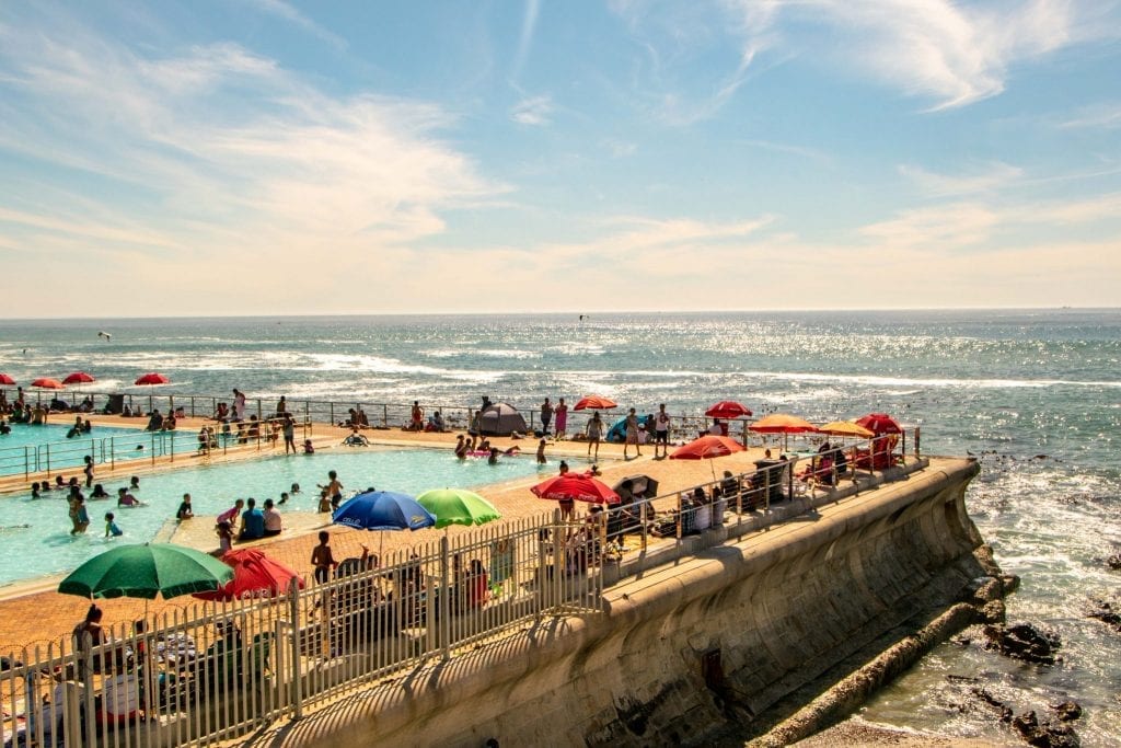 swimming pool built next to the ocean in sea point cape town, one of the best places to visit in cape town