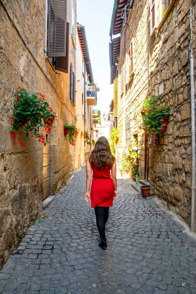 kate storm wandering a small side street in italy budget guide