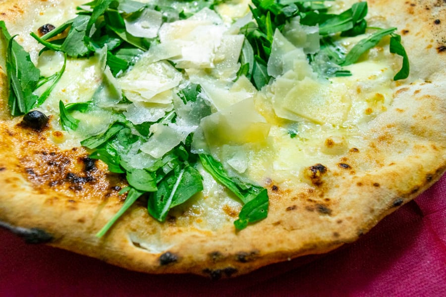 close up of parmesan and rucola pizza at pizzeria di matteo as enjoying during our pizza tour naples italy