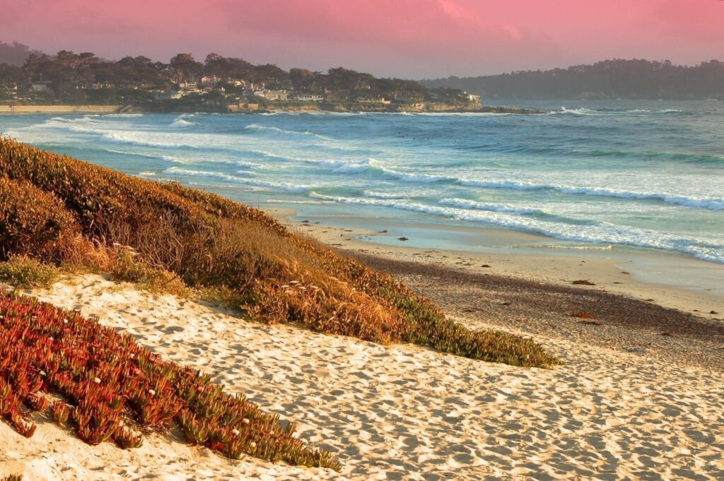 California beach with pink sunset at Carmel-by-the-Sea, one of the best weekend vacations for couples in the United States