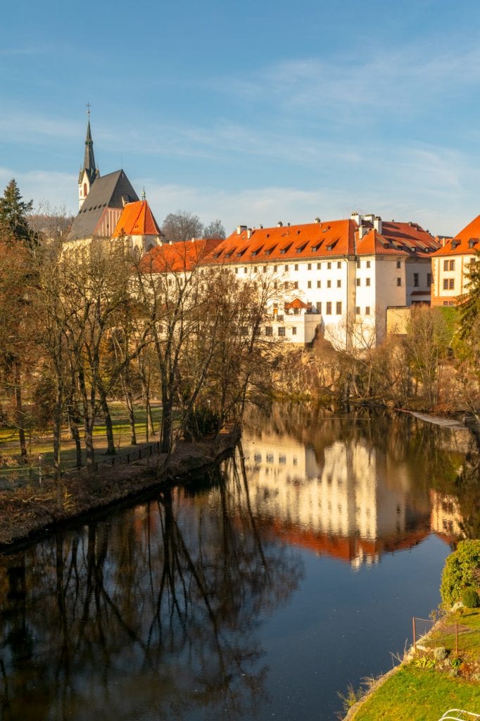 winter view of cesky krumlov czech republic with river in the foreground and building reflecting into it