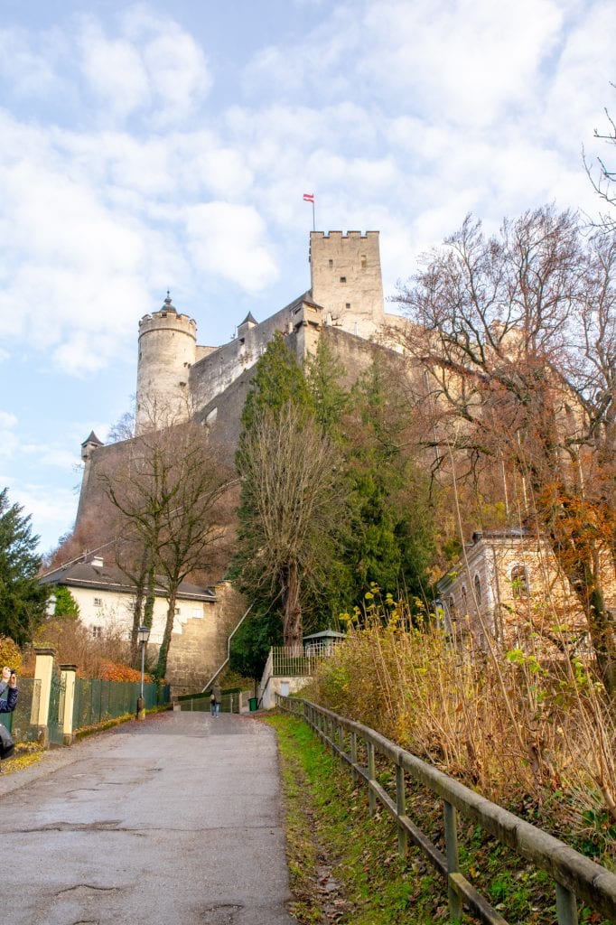 view of hohensalzburg fortress from the road approaching it in winter