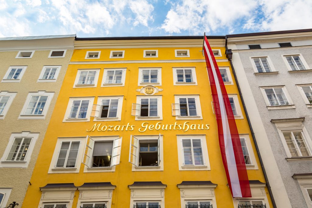 yellow front facade of mozart birthplace, one of the top attractions in salzburg austria