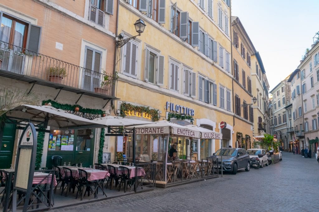 Street of light colored buildings in Centro Storico, Rome in a Day