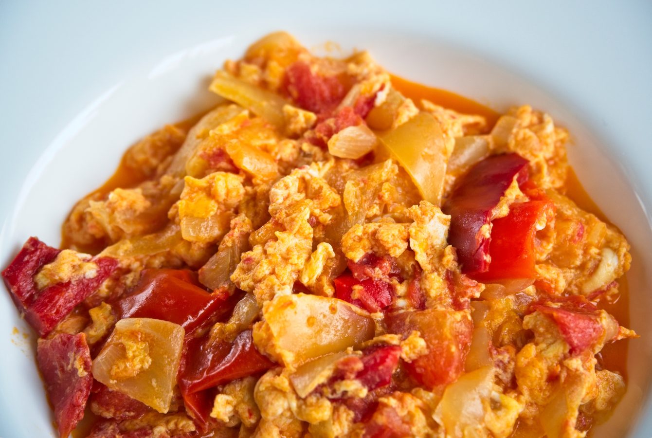 close up of a bowl of typical hungarian LecsĂł soup in a white bowl, must eat budapest food