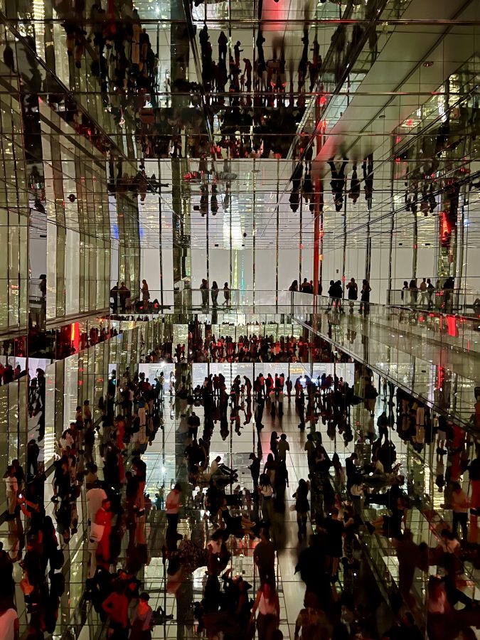 reflective room featuring crowds in summit one vanderbilt at night in new york city
