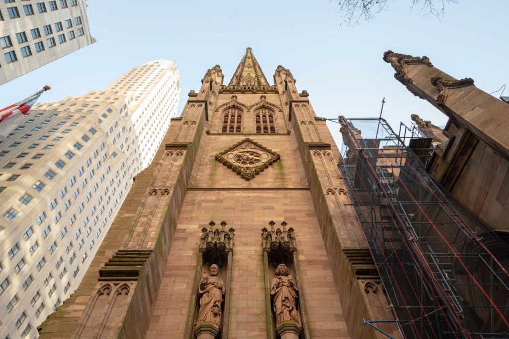view of trinity church front facade as seen looking up during four days in nyc itinerary