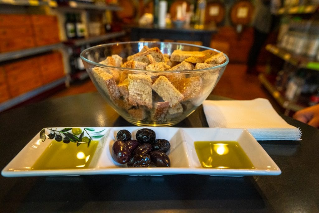 Olive oil, olives, and bread in a bowl served on Athens food tour