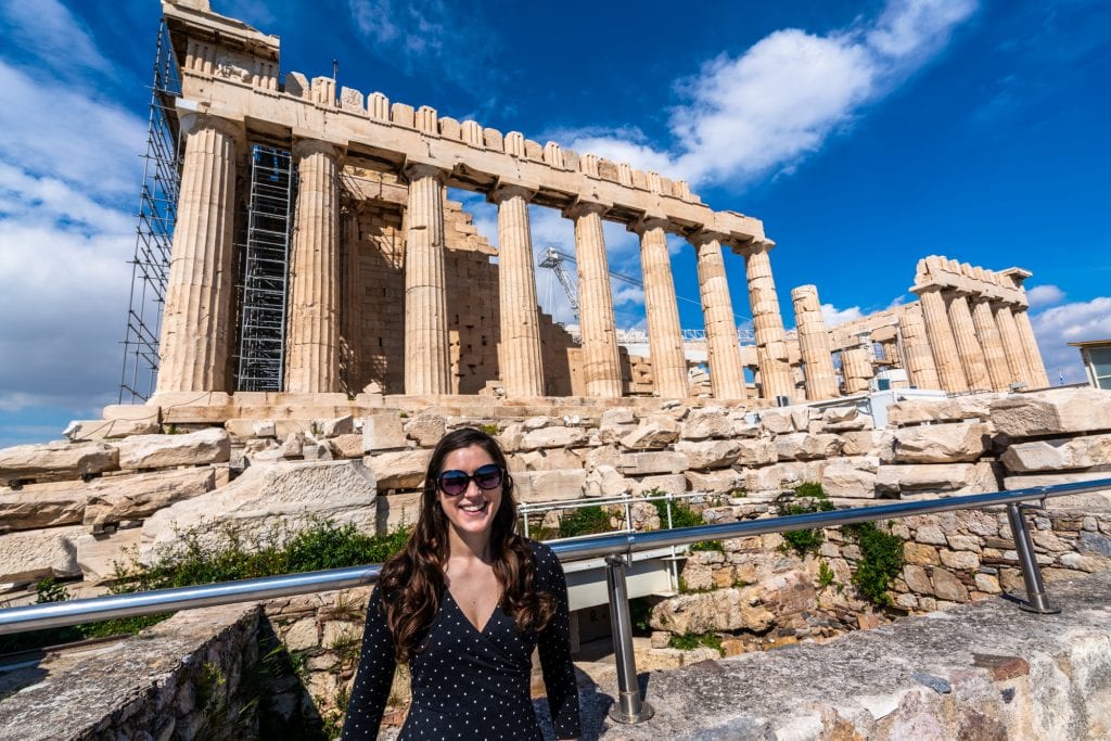 kate storm in front of the parthenon wearing sunglasses when visiting athens greece