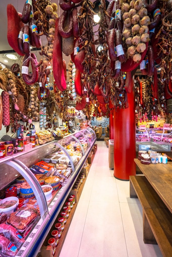 shop with cured meats hanging from ceiling as seen when exploring what to eat in athens greece