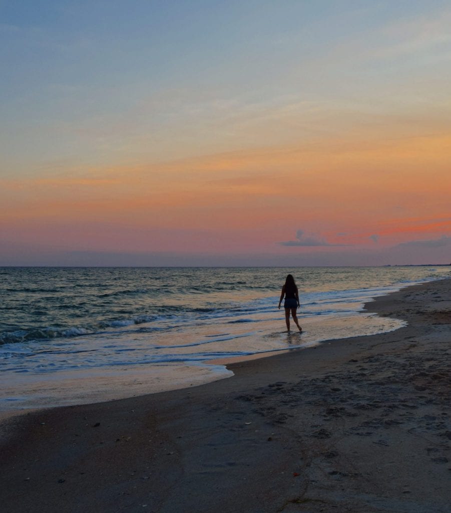 kate storm standing on atlantic beach at sunset. visiting atlantic beach belongs on any list of what to do in beaufort north carolina