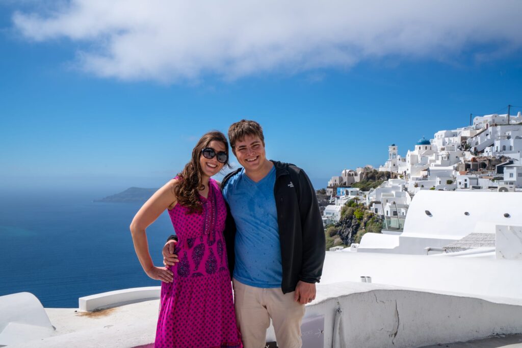 kate storm and jeremy storm hiking from fira to oia on santorini, an essential part of a 3 day santorini itinerary
