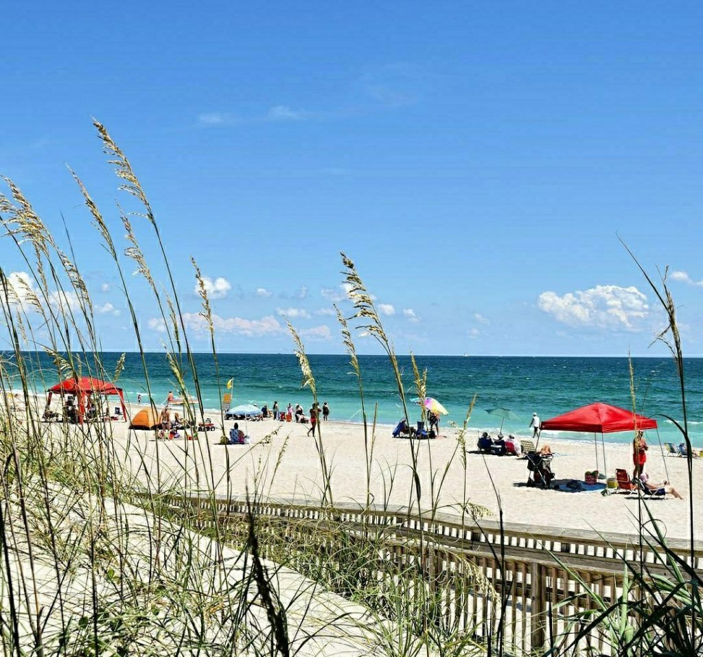 fort macon beach as seen through the sand dunes on a summer dra