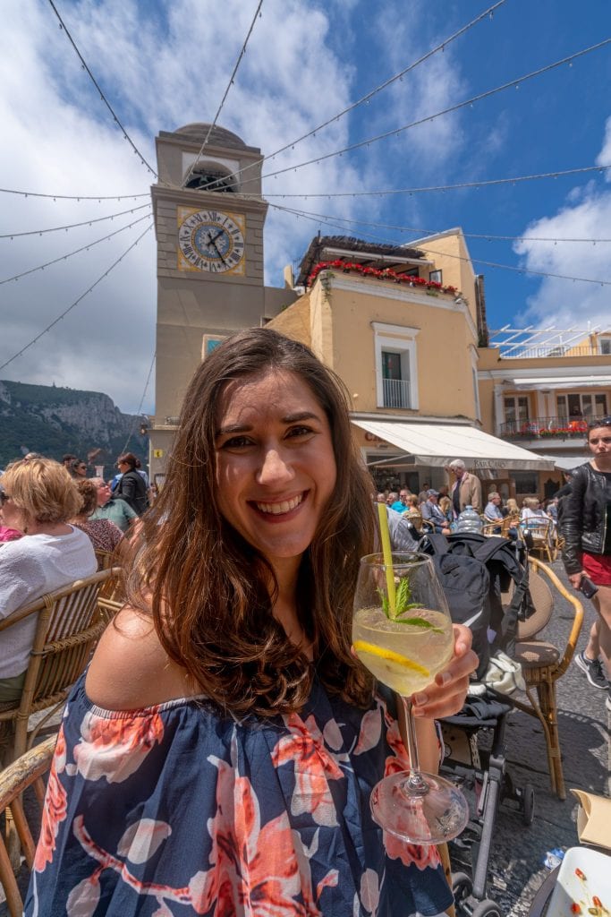 Kate Storm drinking lemon spritz in Piazzetta on a day trip to Capri