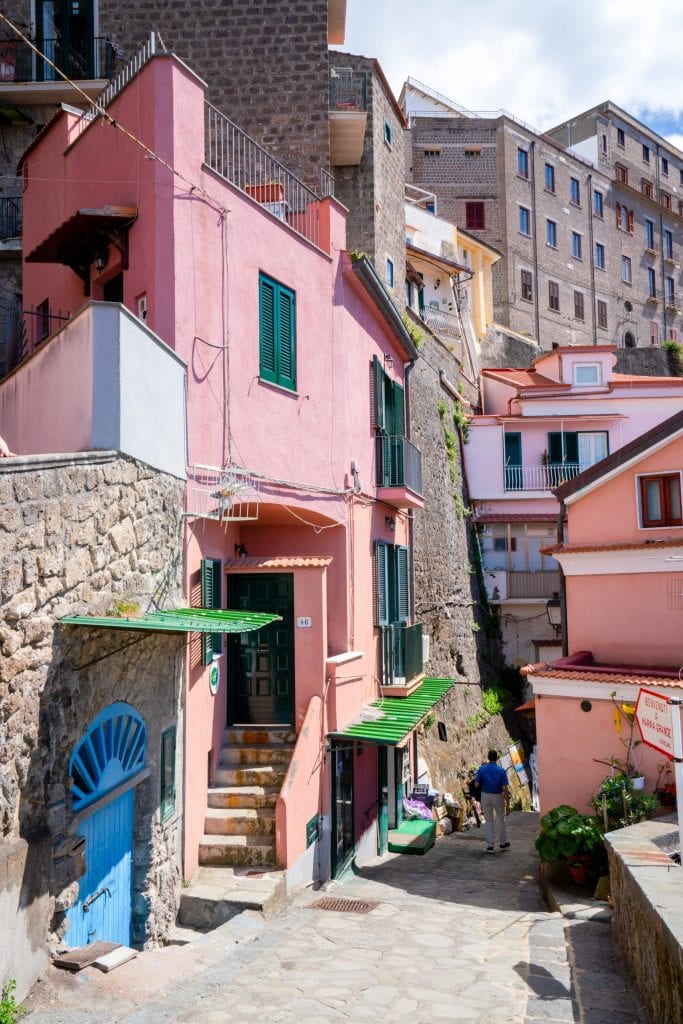 collection of buildings in historic center of sorrento italy with a pink building prominent in the photo
