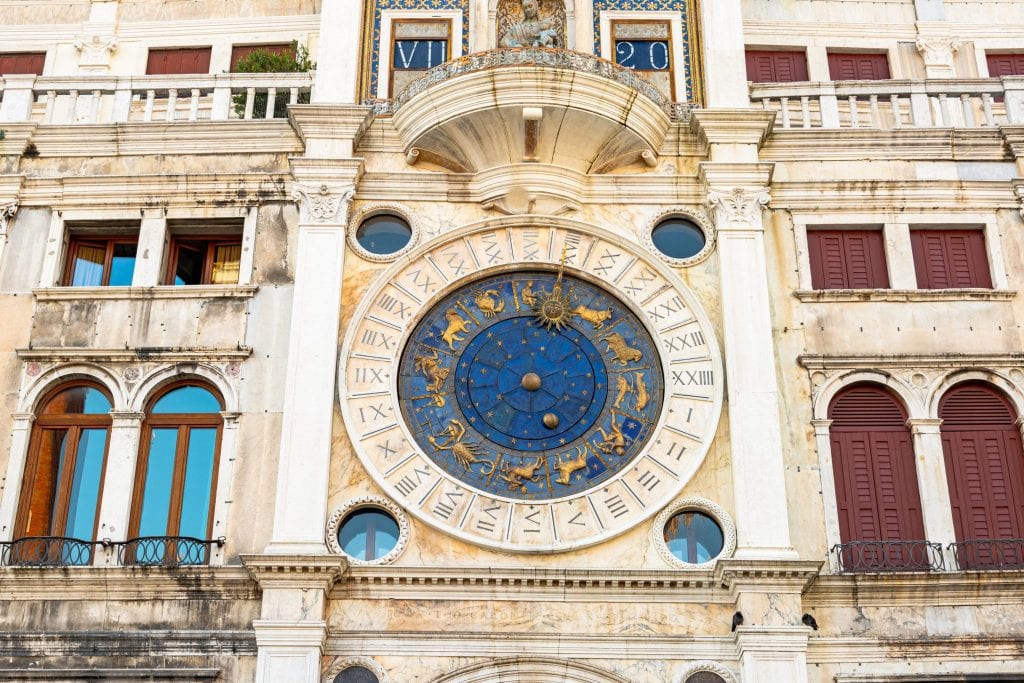 Close up photo of St. Mark's Clocktower with blue face visible. Touring the inside of this beautiful clocktower is a great way to see Venice off the beaten path.