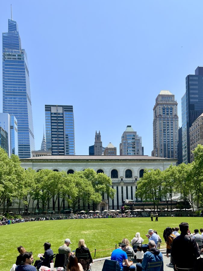 bryant park on a sunny day with summit one vanderbilt to the left nyc