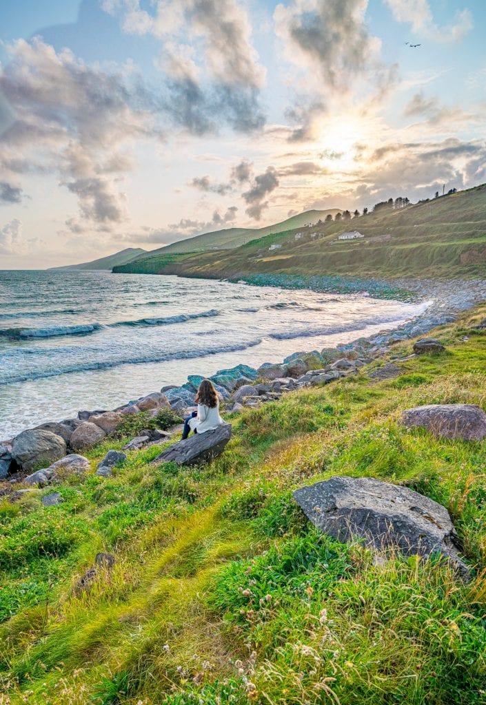 Kate Storm in a cream cardigan near Inch Beach Ireland at sunset