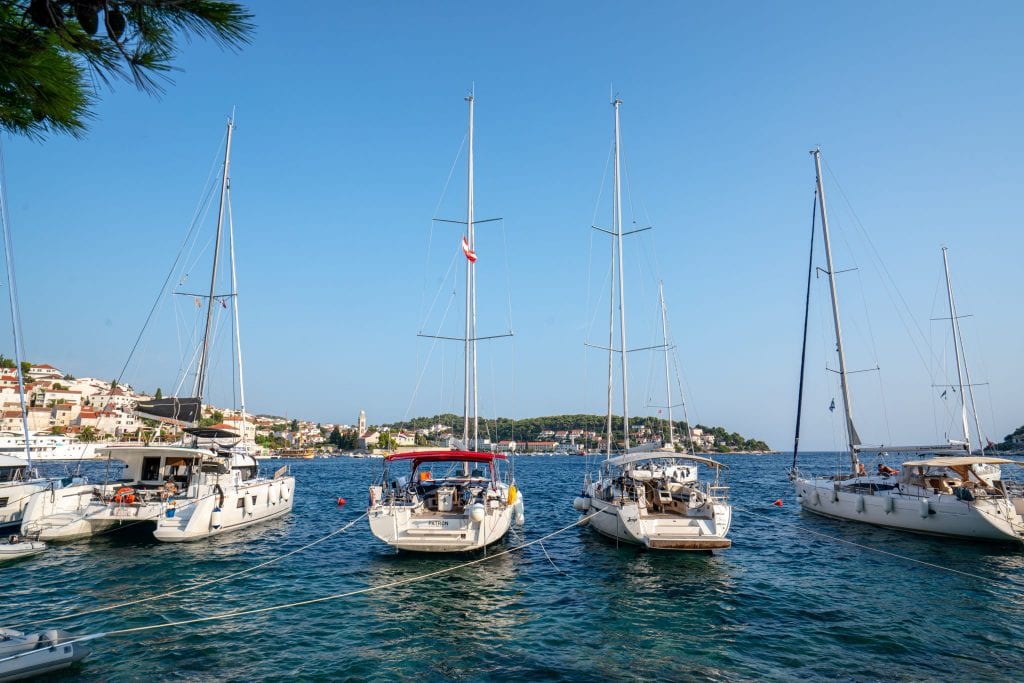 Four sailboats parked near Hvar Croatia--walking around the waterfront is one of the best things to do in Hvar Croatia!