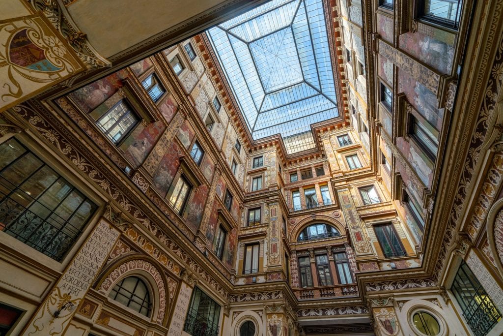 Photo of Galleria Sciarra Rome looking up, showing the vaulted glass ceiling in the center