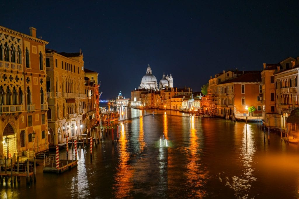 Photo of the Venetian Grand Canal at night with lights reflecting on the water--when deciding what to do in Venice at night, make sure you include seeking out a few views like this.