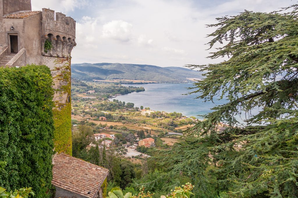 lake bracciano from above with castle turret in the left foreground